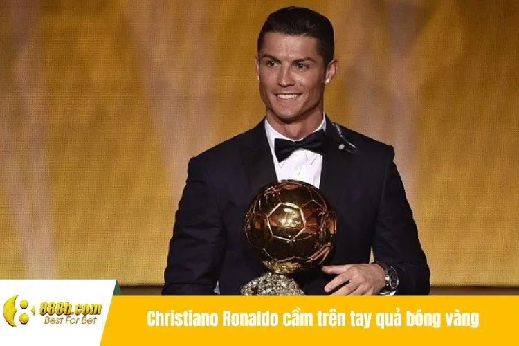 Christiano Ronaldo cầm trên tay quả bóng vàng